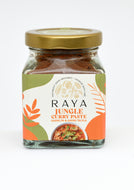 Jar of Raya Jungle Curry Paste with a gold lid on a white background