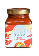 Jar of Raya Red Curry Paste with a gold lid on a white background